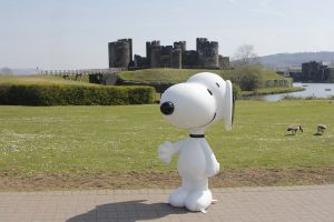 An image of Snoopy stood in front of Caerphilly Castle