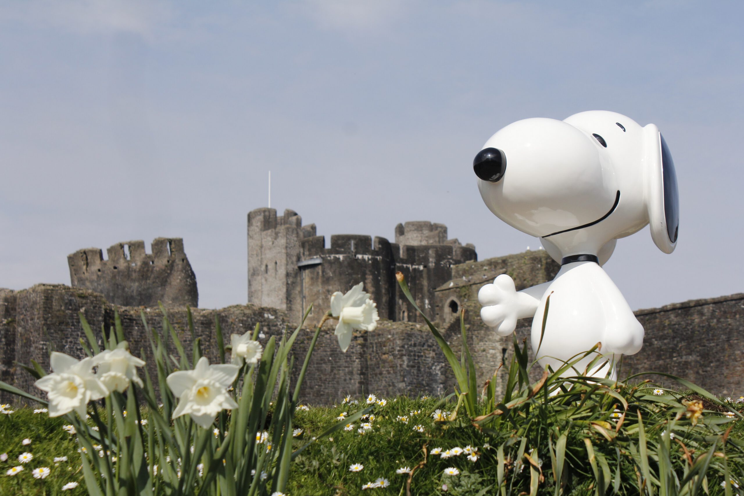 An image of Snoopy stood in front of Caerphilly Castle
